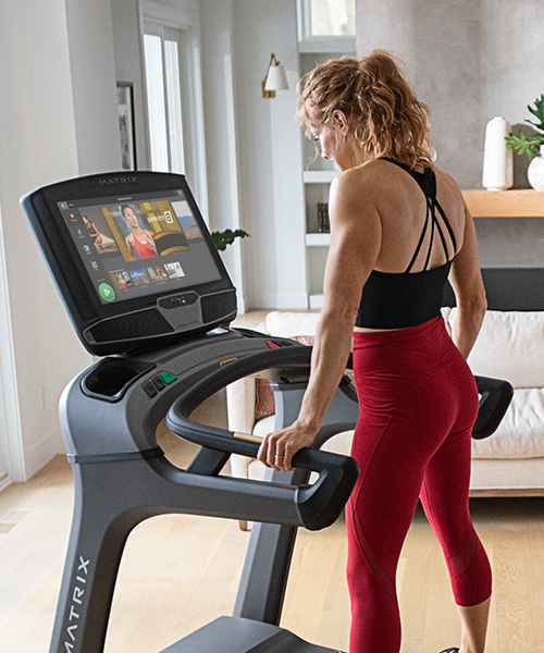 Woman running on treadmill in home